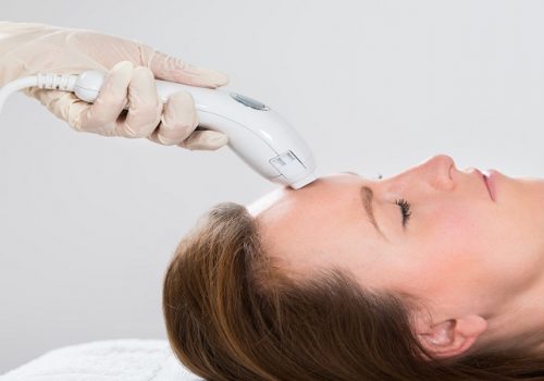 Young Woman Receiving Laser Hair Removal Treatment At Beauty Center